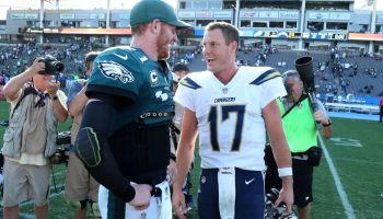 Carson Wentz and Philip Rivers talk after a game.