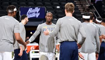 Pacers guard Caris LeVert shakes hands before the start of a game.