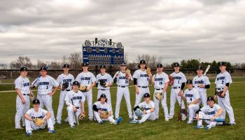 The Columbus North Baseball team poses in front of the scoreboard on their field