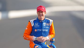 Scott Dixon poses for a photo at the Indianapolis Motor Speedway with his red pole winner hat on