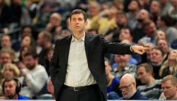 Brad Stevens coaches on the sidelines against the Indiana Pacers as he points to a position on the court