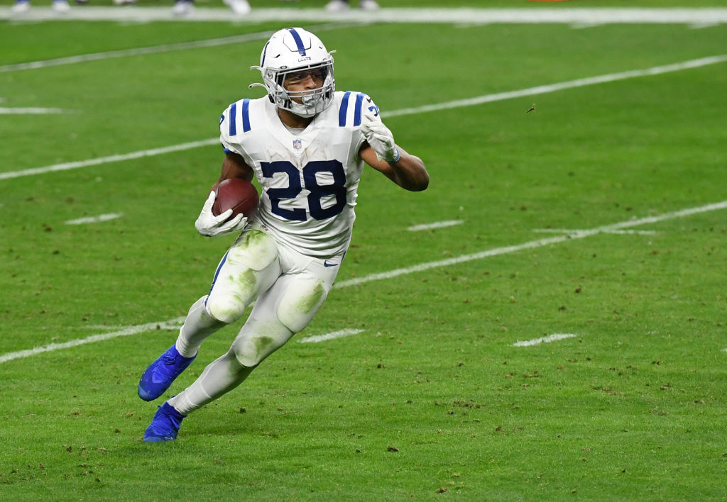 Colts running back Jonathan Taylor runs in a road game.