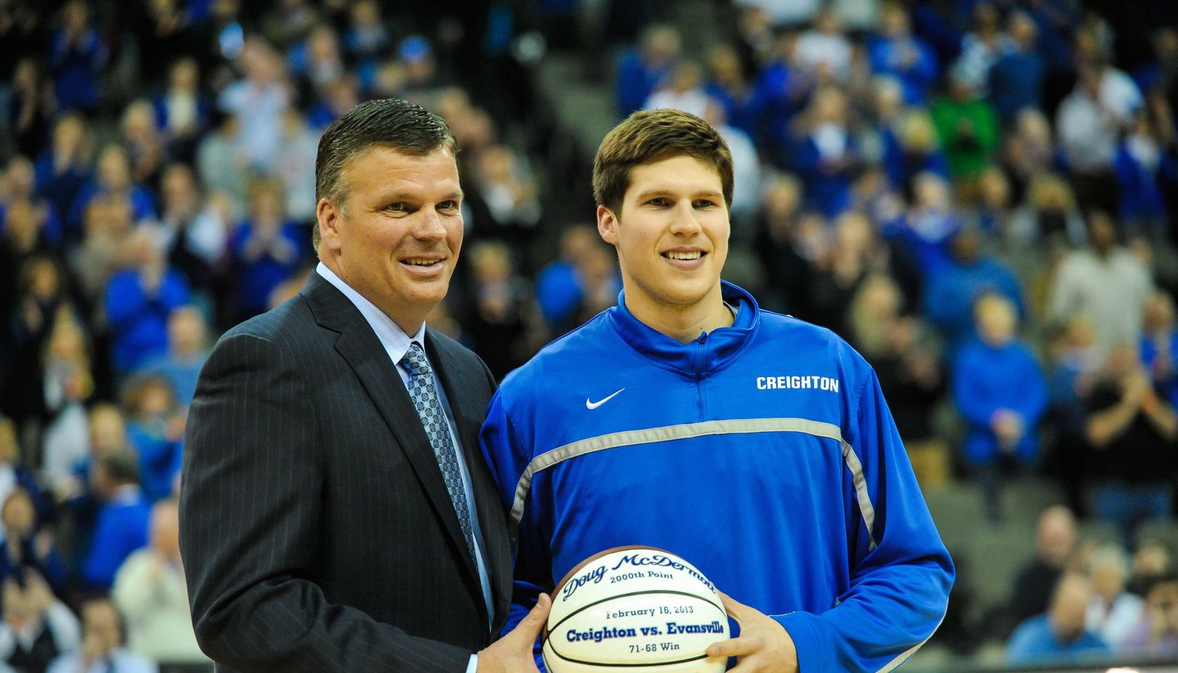 Doug McDermott #3 accepts a ball from his father head coach Greg McDermott of the Creighton Bluejays before the game against the Southern Illinois Salukis at the CenturyLink Center on February 19, 2013 in Omaha, Nebraska.