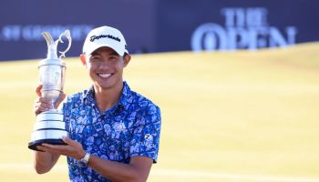 Collin Morikawa poses after his Open Championship win on the 18th green
