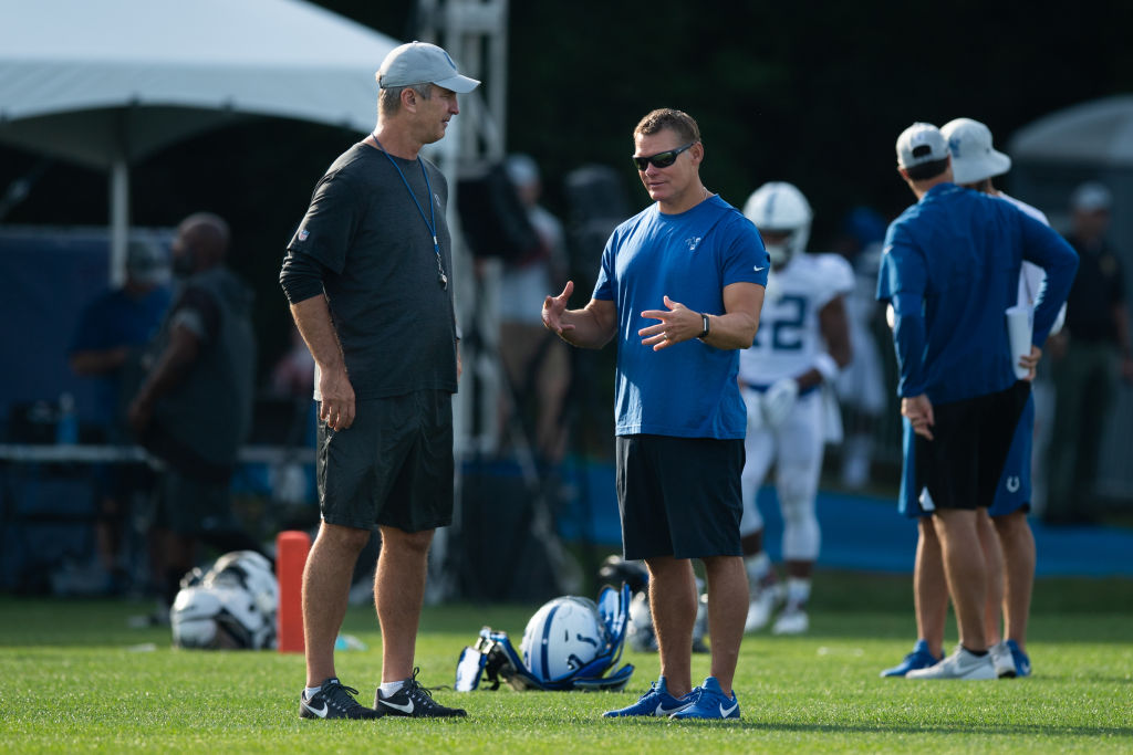 Frank Reich and Chris Ballard talk on the practice field.