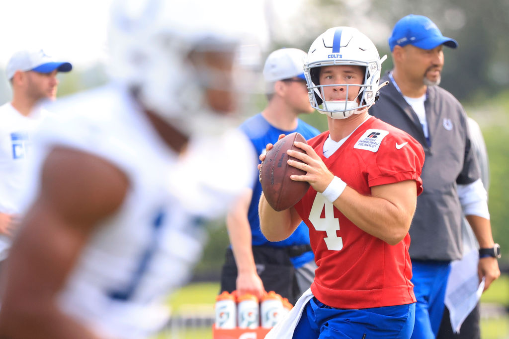 Sam Ehlinger drops back to pass at Indianapolis Colts training camp and eyes a wide receiver on the near side of the screen