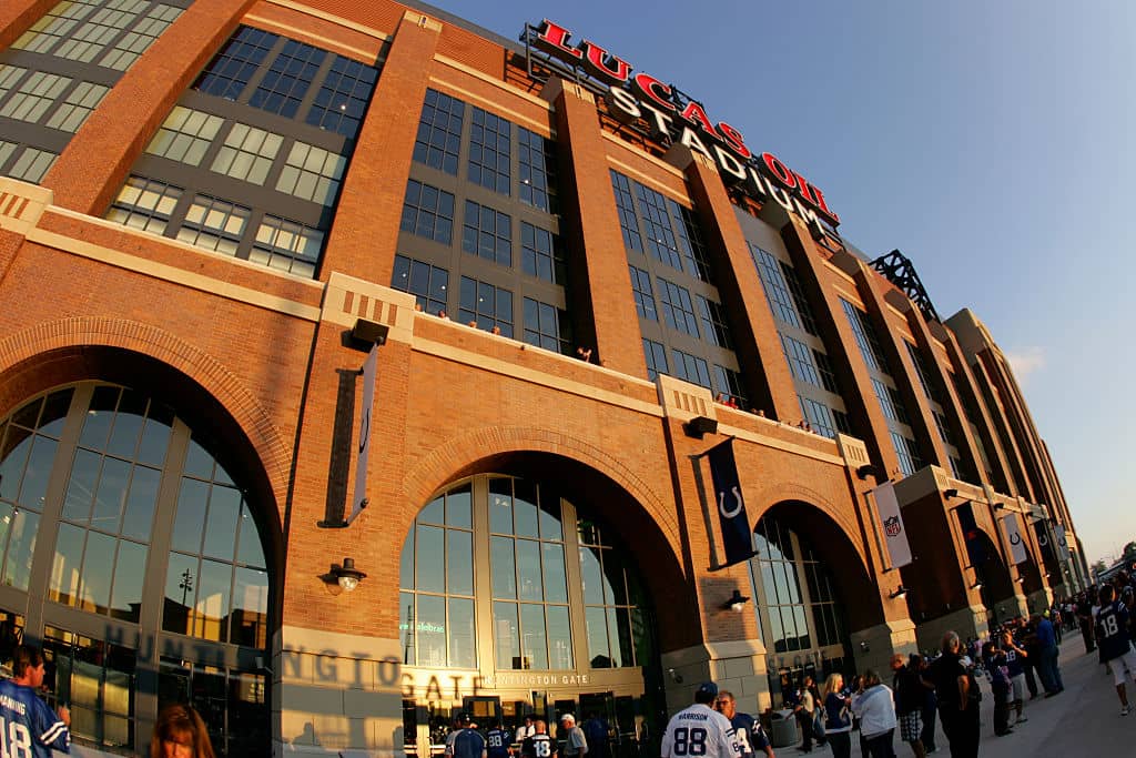 An outside shot of Lucas Oil Stadium with the sun glaring off the front of the building
