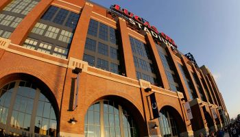 An outside shot of Lucas Oil Stadium with the sun glaring off the front of the building