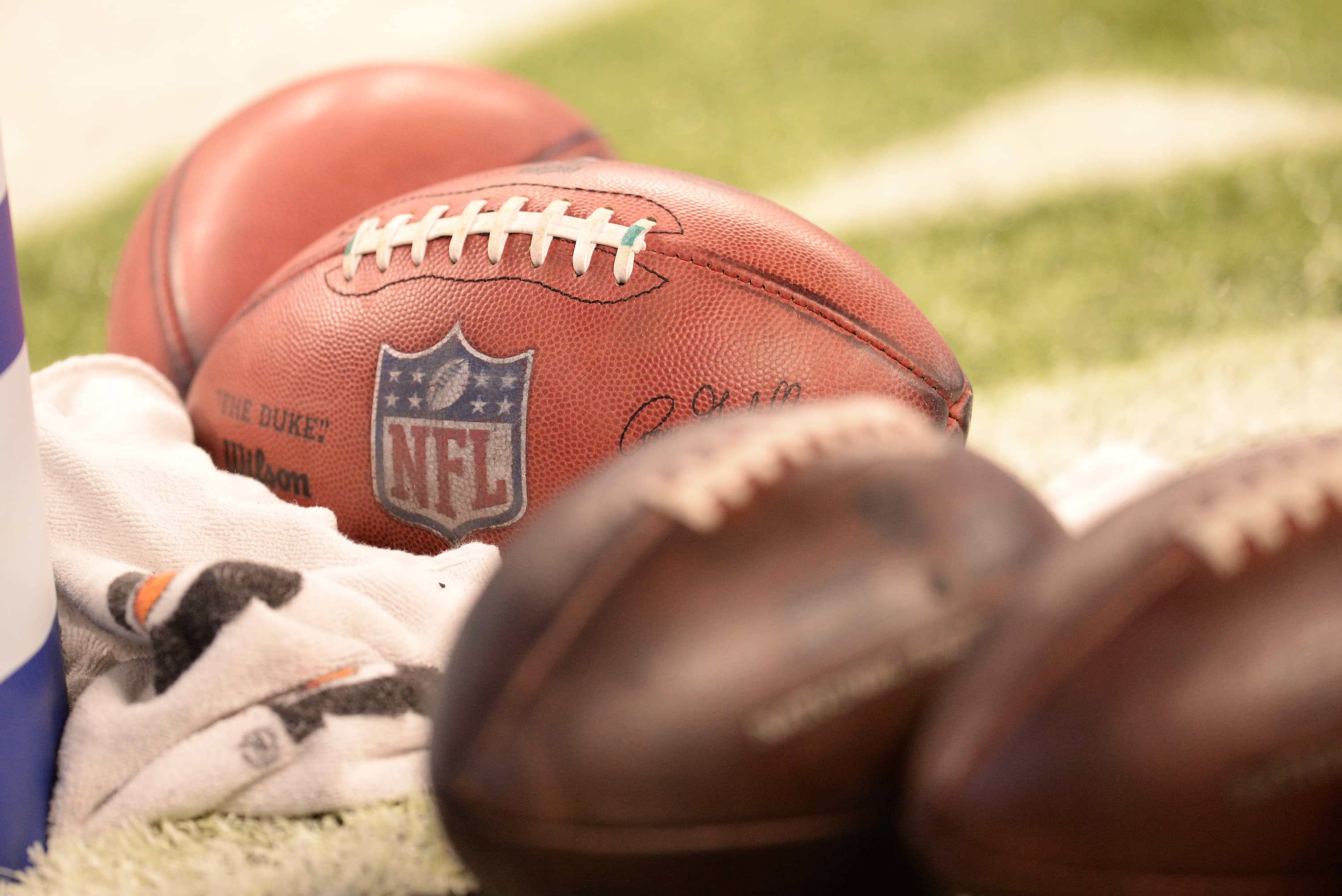 NFL footballs laying on field