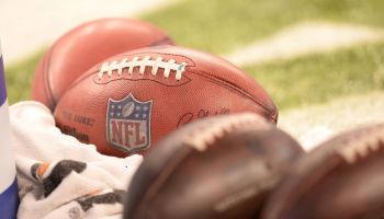 NFL footballs laying on field