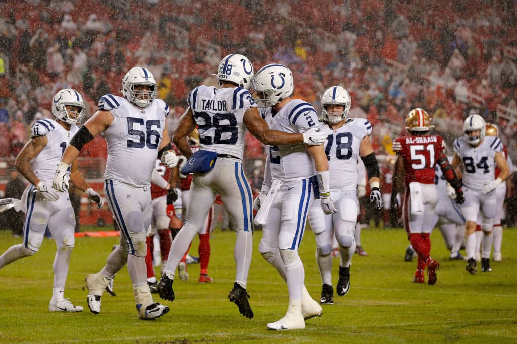 Colts running back Jonathan Taylor celebrates with Carson Wentz in the end zone as he scores against the 49ers