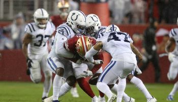 Colts defensive players tackling 49ers ball carrier
