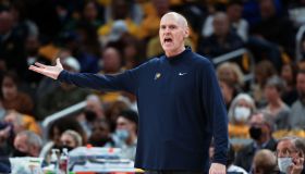 Rick Carlisle on the Pacers sideline shouts in the direction of the floor