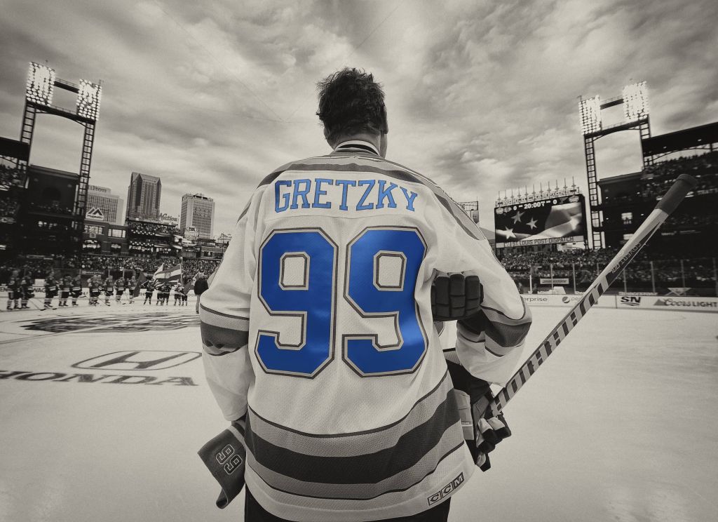 Wayne Gretzky prepares to play in an NHL outdoor alumni game looking up at the stands in a baseball ballpark