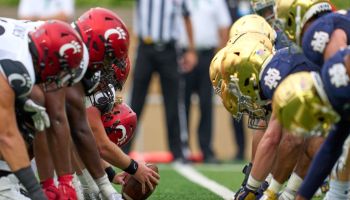 Cincinnati and Notre Dame lineup in the trenches with offensive and defensive lineman on the ball
