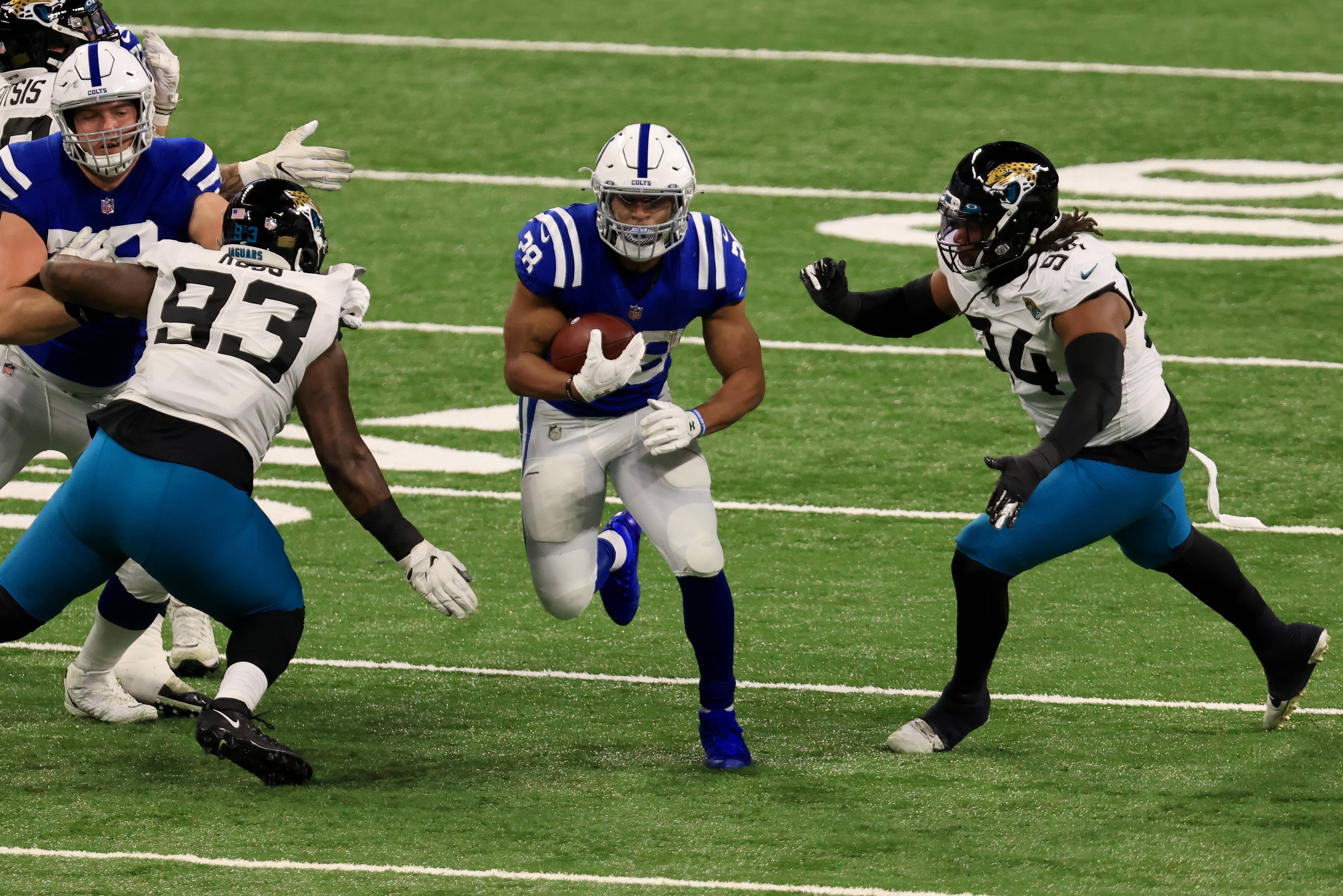 Jonathan Taylor running past jaguars defenders