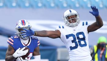 T.J. Carrie lunges his arm in front of Stefon Diggs as the Bills wide receiver makes a catch