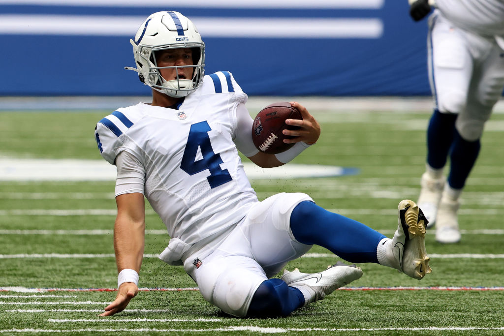 Sam Ehlinger slides near the first down marker in a game at Lucas Oil Stadium against the Carolina Panthers