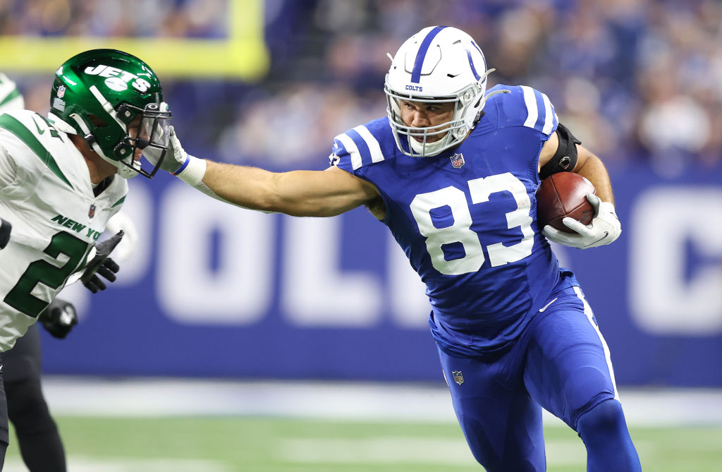 Colts TE-Kylen Granson stiff arms a defender.