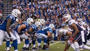 The Colts and Patriots line up in the trenches at Lucas Oil Stadium