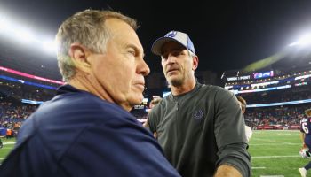 Frank Reich talks with Bill Belichick shake hands after a game.