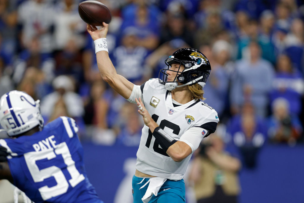 Trevor Lawrence throws a pass for the Jacksonville Jaguars as Indianapolis Colts pass rusher Kwity Paye chases