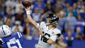 Trevor Lawrence throws a pass for the Jacksonville Jaguars as Indianapolis Colts pass rusher Kwity Paye chases
