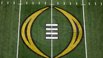 A close up shot of midfield and the College Football Playoff logo in the middle of Lucas Oil Stadium