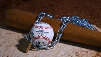 baseball and bat wrapped in a lock and chain