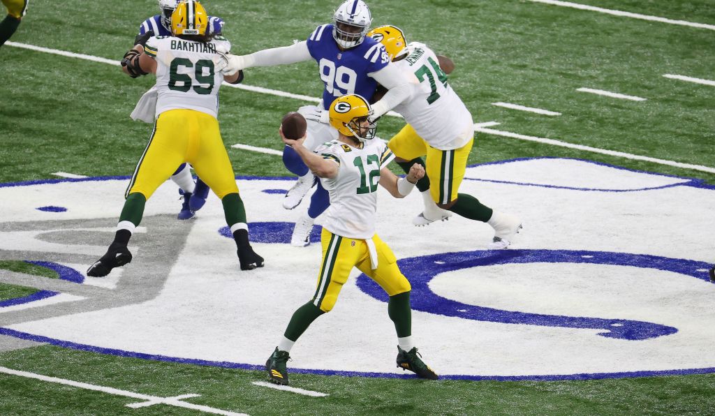 Aaron Rodgers throws a pass for the Packers against the Colts with his offensive line blocking for him