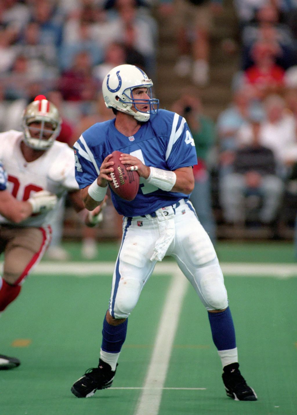 Quarterback Jim Harbaugh #4 of the Indianapolis Colts looks to pass against the San Francisco 49ers during a game at the RCA Dome
