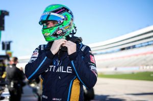 Conor Daly putting his helmet on