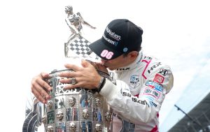 Helio Castroneves kissing the trophy
