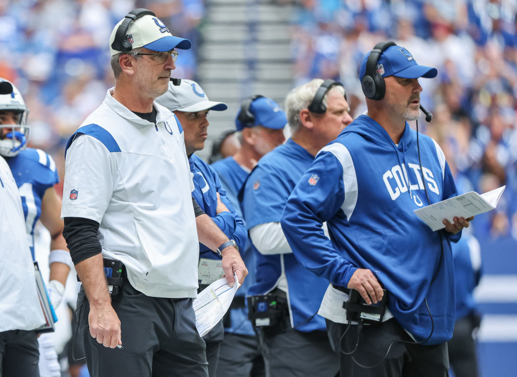 Colts head coach Frank Reich and Gus Bradley look on from the sideline.
