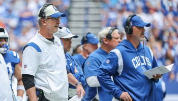 Colts head coach Frank Reich and Gus Bradley look on from the sideline.