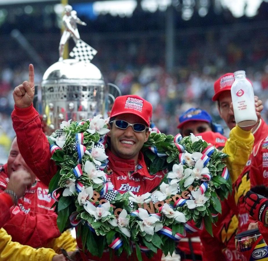 Juan Montoya of Colombia holds the jug of milk aft