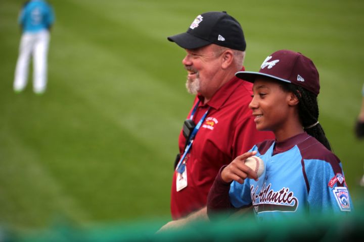 Charlie Jones, supervisor of Outfield Security, talks with Taney Dragons pitcher Mo'ne Davis at Lamade Stadium during the Little League World Series in Williamsport. Photo by Natalie Kolb 8/20/2014