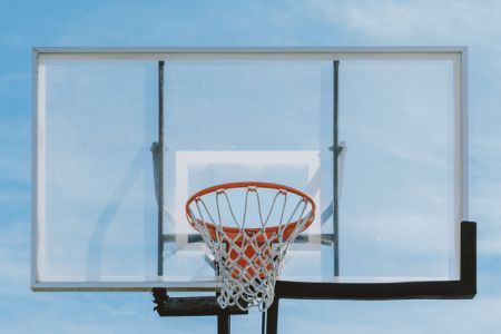 Basketball Backboard and Hoop Against Blue Sky