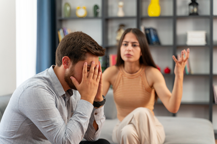 Young man frustrated by his girlfriend who constantly argues with him