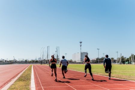 Athletes running on track and field stadium
