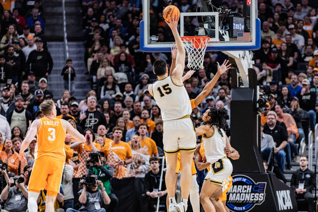 Zach Edey (C) of the Purdue Boilermakers in action against...