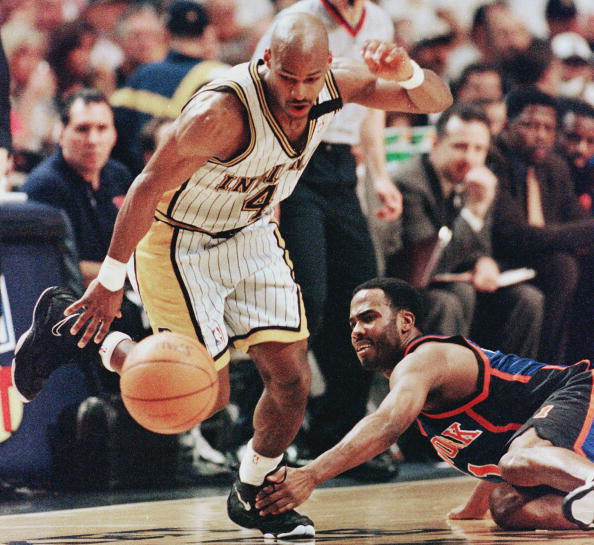 Travis Best (L) of the Indiana Pacers chases after