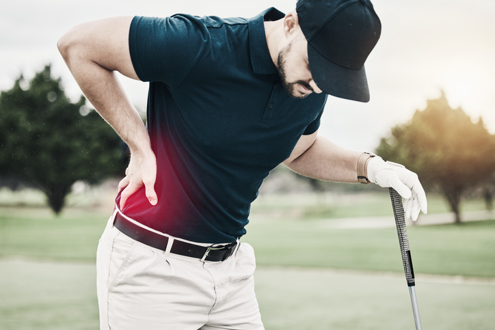 Sports, muscle and golf, man with back pain during game on course, massage and relief in health and wellness. Green, hands on injury in support and golfer with body ache at golfing workout on grass.