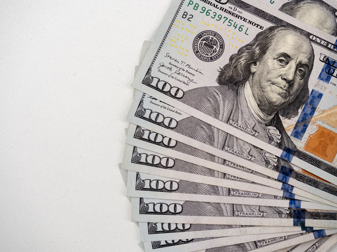 A section of Benjamin Franklin's face image on 100 dollars bill banknote cash, money fan, isolated background. One hundred numbers on bill banknotes piles, top view.