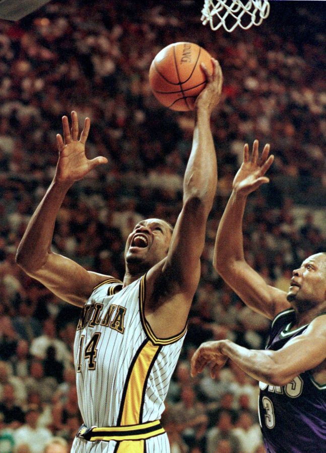 Indiana Pacers forward Sam Perkins(L) gets a shot