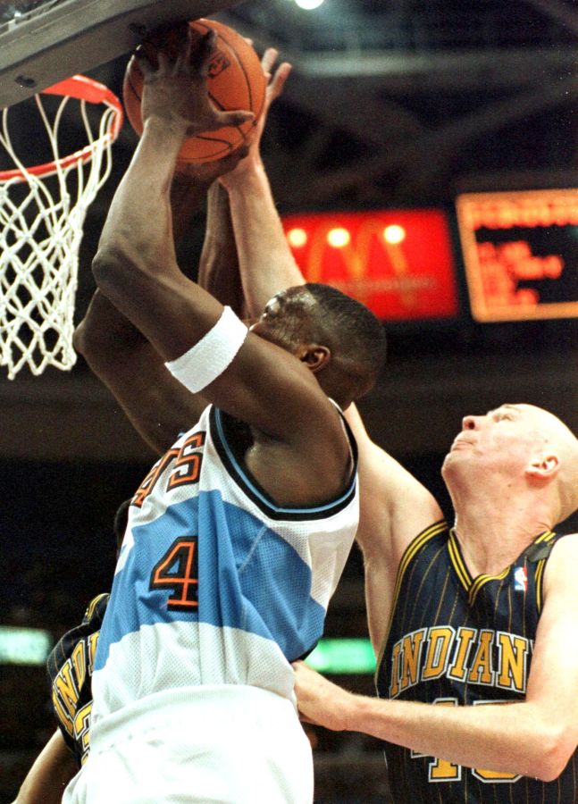 Indiana Pacers Rik Smits (R) blocks the shot from