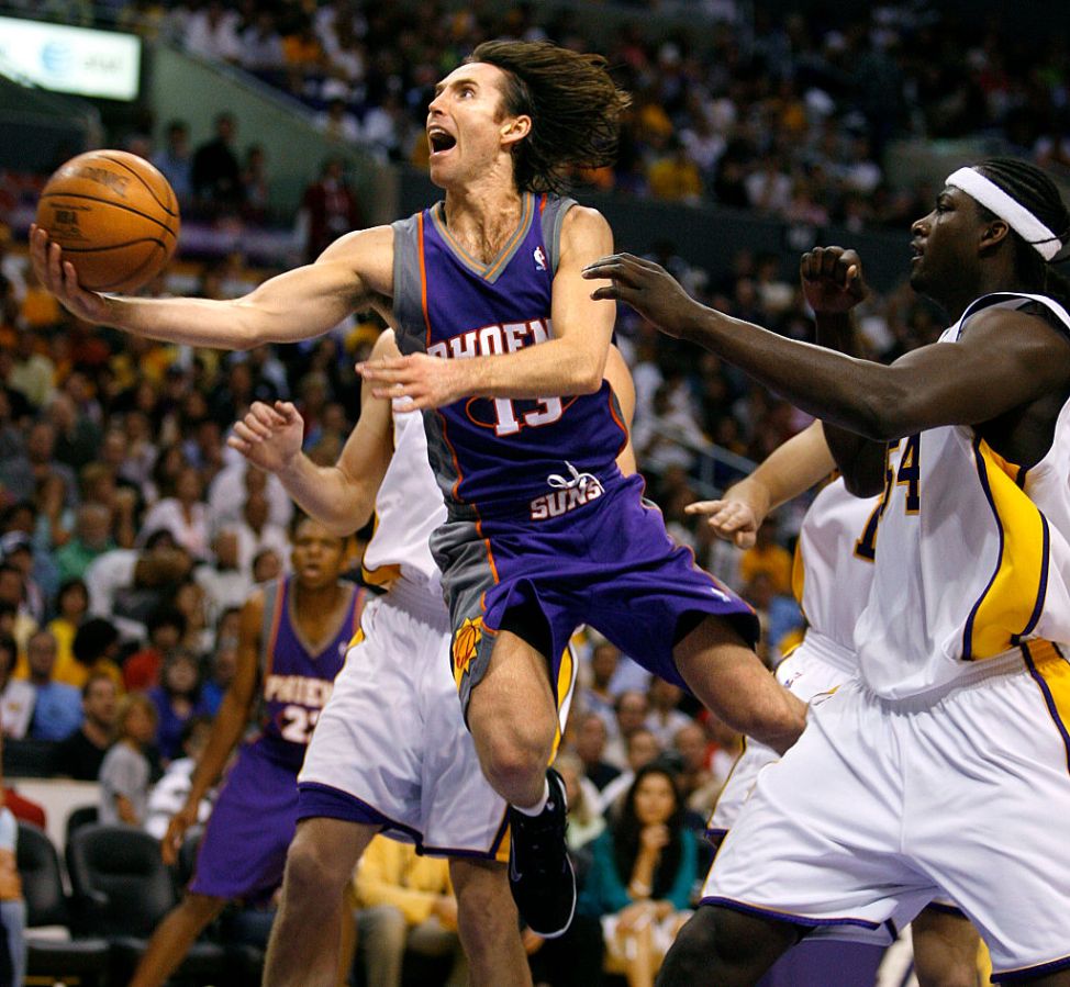 Phoenix Suns Steve Nash drives to the basket but misses the layup in front of Lakers Kwame Brown in