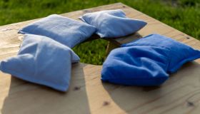 Cornhole game with blue bags