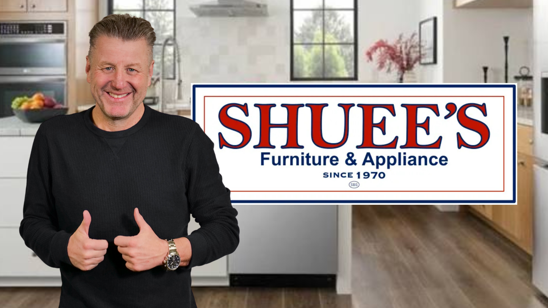 A smiling man in a black sweater standing in front of a "Shuee's Furniture & Appliance" sign, giving a thumbs up.